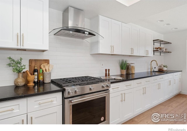 7102 S Harrison Ct, Centennial, CO 80122 - kitchen with stainless steel range with gas stovetop, wall chimney exhaust hood, open shelves, white cabinetry, and a sink