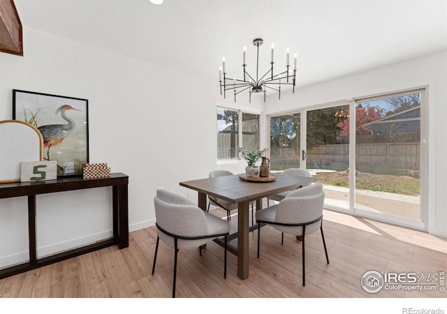 7102 S Harrison Ct, Centennial, CO 80122 - dining area featuring a chandelier, light wood finished floors, and baseboards