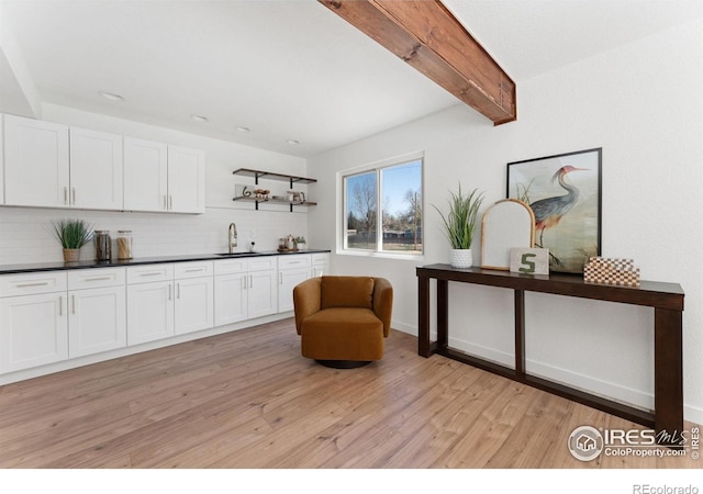 7102 S Harrison Ct, Centennial, CO 80122 - living area with light wood-style floors, recessed lighting, beam ceiling, and bar