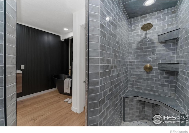 7102 S Harrison Ct, Centennial, CO 80122 - bathroom featuring wood finished floors, tiled shower, and recessed lighting