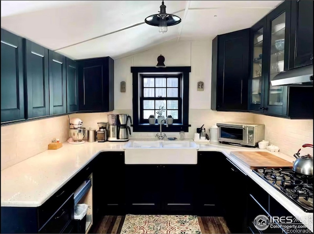 501 Main St, Boulder, CO 80302 - kitchen featuring lofted ceiling, decorative backsplash, light countertops, stovetop, and a ceiling fan