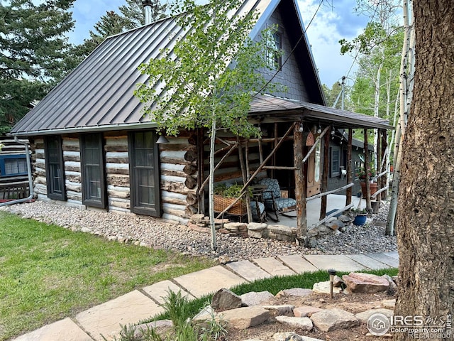 501 Main St, Boulder, CO 80302 - view of front of home featuring a standing seam roof, log exterior, and a metal roof