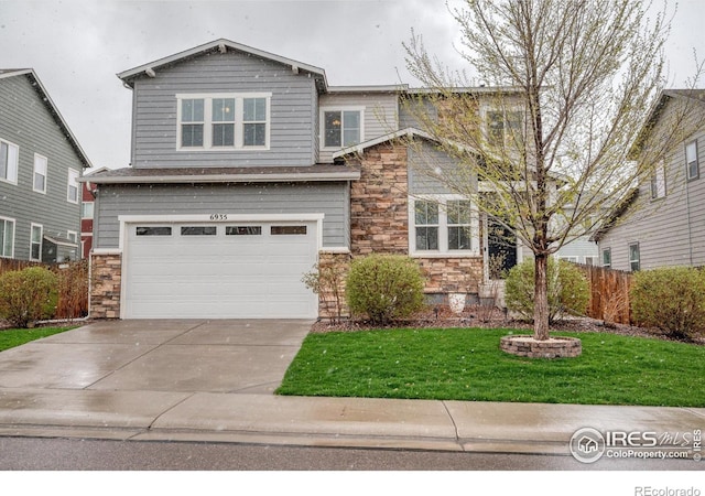 craftsman inspired home with fence, a front lawn, an attached garage, driveway, and stone siding