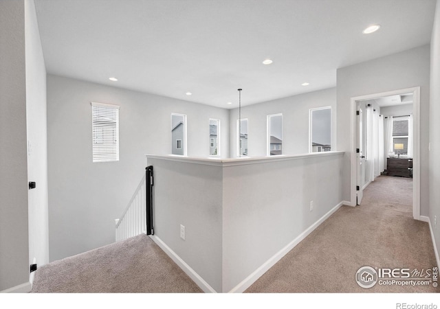 hallway with recessed lighting, carpet floors, a wealth of natural light, and an upstairs landing