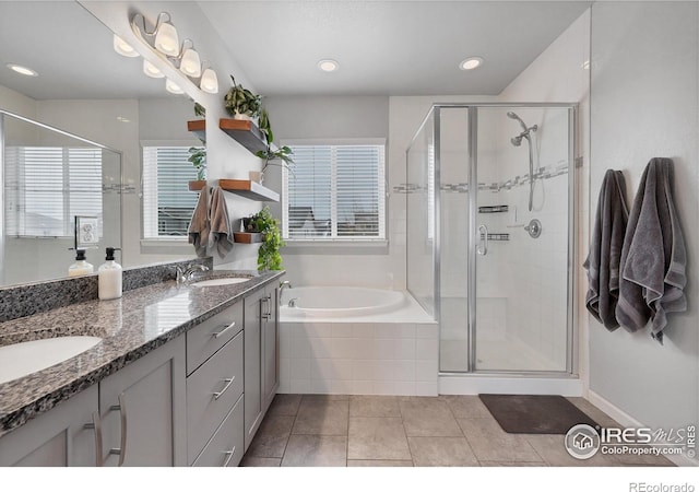 bathroom featuring a sink, double vanity, and a stall shower