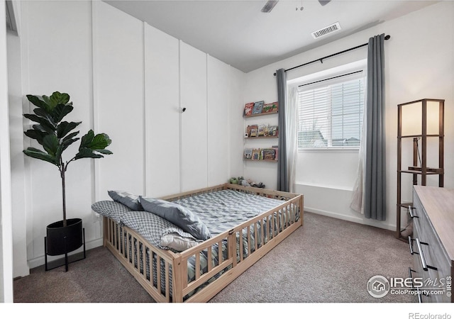 bedroom with baseboards, visible vents, and carpet floors