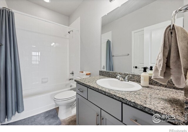 bathroom with toilet, vanity, and shower / bath combination with curtain