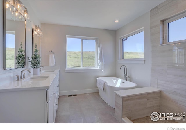 1041 Turnberry Cir, Louisville, CO 80027 - bathroom with double vanity, a freestanding tub, and recessed lighting