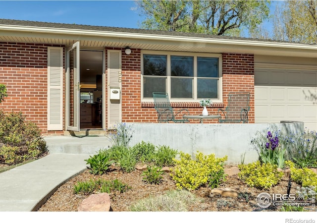 195 S 35th St, Boulder, CO 80305 - view of exterior entry featuring brick siding and an attached garage
