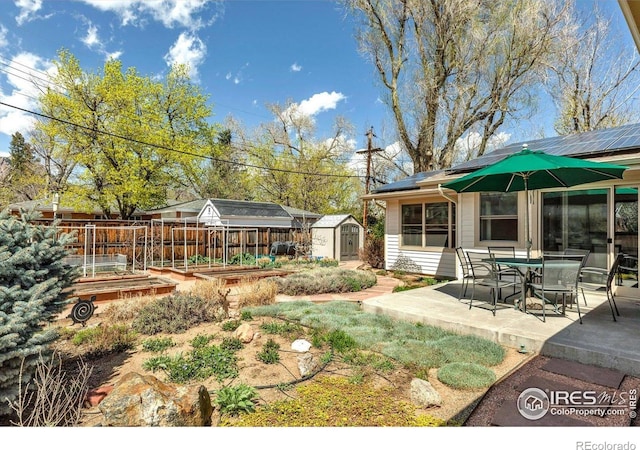 195 S 35th St, Boulder, CO 80305 - view of yard featuring a vegetable garden, an outbuilding, outdoor dining area, a shed, and a patio