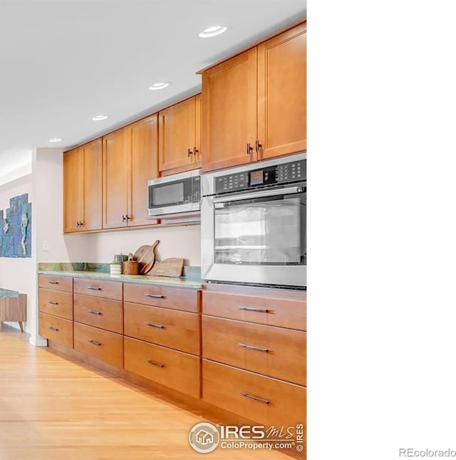 195 S 35th St, Boulder, CO 80305 - kitchen with recessed lighting, light wood finished floors, stainless steel microwave, light countertops, and oven