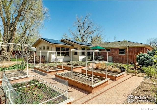 195 S 35th St, Boulder, CO 80305 - back of property with brick siding, a garden, and solar panels