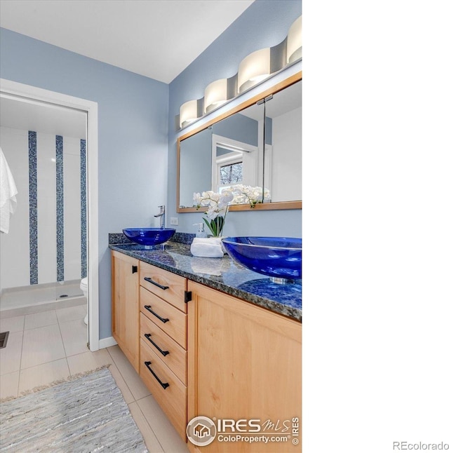 195 S 35th St, Boulder, CO 80305 - full bathroom featuring a sink, toilet, tile patterned flooring, a shower stall, and double vanity