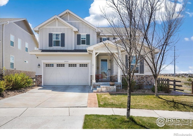 24222 E Canyon Pl, Aurora, CO 80016 - craftsman-style home featuring a garage, fence, stone siding, board and batten siding, and driveway