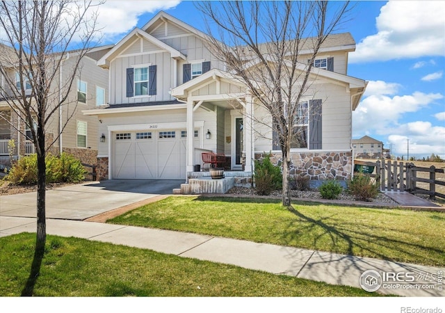 24222 E Canyon Pl, Aurora, CO 80016 - craftsman house featuring fence, board and batten siding, driveway, and stone siding