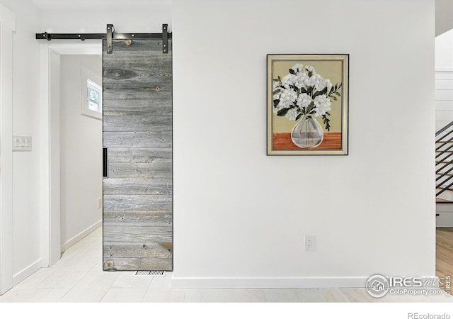 details with baseboards and a barn door