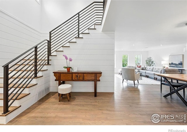 entryway featuring visible vents, stairs, and wood finished floors