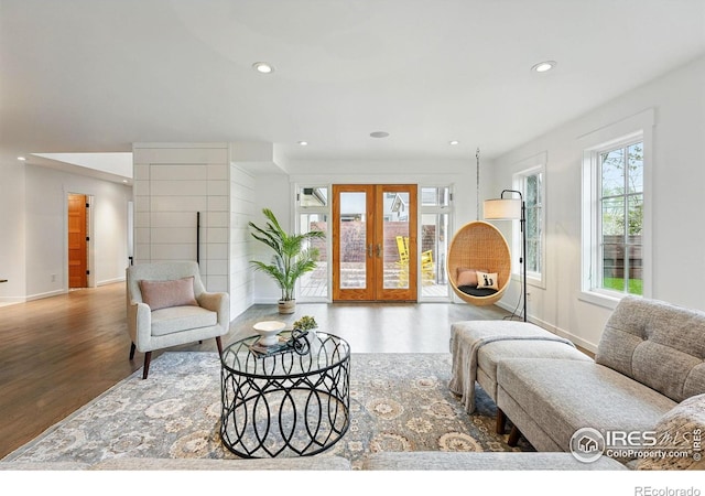 living room featuring french doors, recessed lighting, baseboards, and wood finished floors