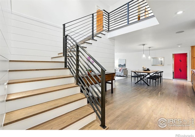 stairway featuring wood finished floors