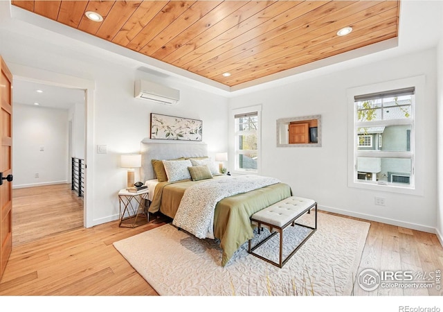 bedroom with an AC wall unit, a tray ceiling, wooden ceiling, and multiple windows