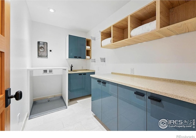 kitchen with open shelves, recessed lighting, a sink, light tile patterned floors, and blue cabinetry