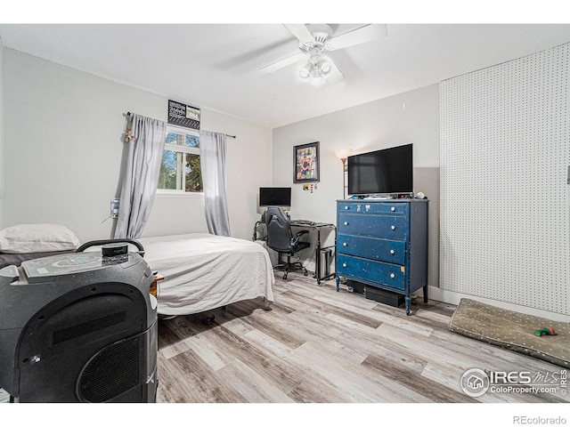bedroom featuring ceiling fan and wood finished floors