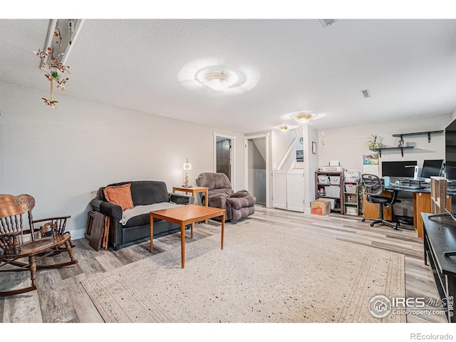 living room featuring wood finished floors and visible vents