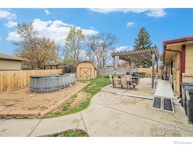 view of patio with a pergola, a fenced backyard, a storage unit, a fenced in pool, and outdoor dining space