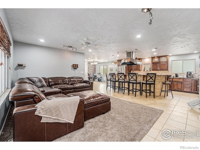 living area with recessed lighting, ceiling fan, and light tile patterned floors