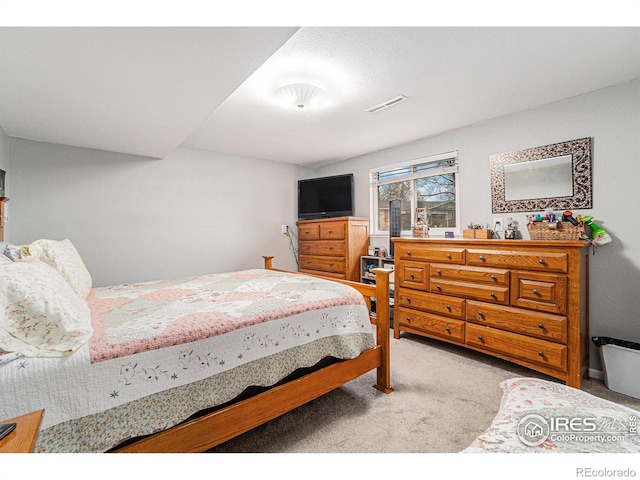 carpeted bedroom with visible vents