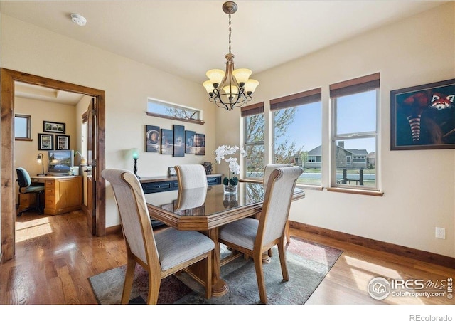 3560 Peruvian Torch Dr, Loveland, CO 80537 - dining room featuring a chandelier, baseboards, wood finished floors, and an office area