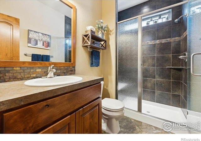 3560 Peruvian Torch Dr, Loveland, CO 80537 - bathroom featuring a stall shower, toilet, vanity, and tile patterned flooring