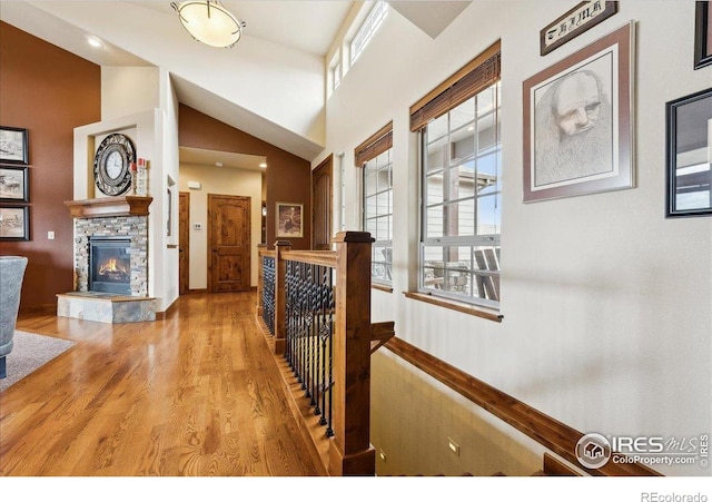 3560 Peruvian Torch Dr, Loveland, CO 80537 - corridor with an upstairs landing, wood finished floors, and high vaulted ceiling