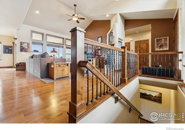 3560 Peruvian Torch Dr, Loveland, CO 80537 - staircase featuring wood finished floors, ceiling fan, recessed lighting, and high vaulted ceiling