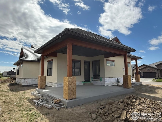 2805 Potomac Ct, Berthoud, CO 80513 - rear view of house featuring a porch and stucco siding