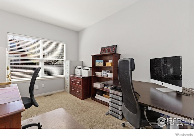 home office featuring light colored carpet, baseboards, and visible vents