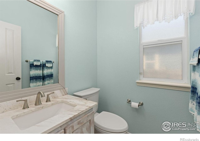 bathroom featuring toilet and vanity
