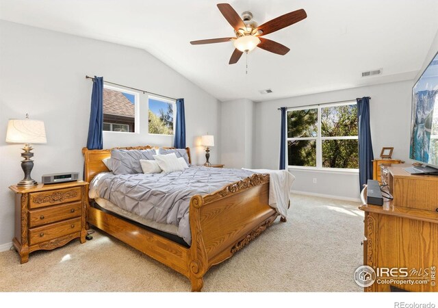 carpeted bedroom featuring baseboards, ceiling fan, vaulted ceiling, and visible vents