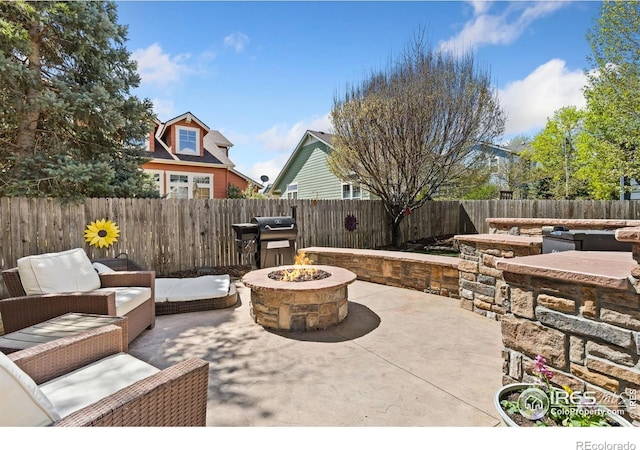 view of patio / terrace with a fenced backyard and an outdoor fire pit