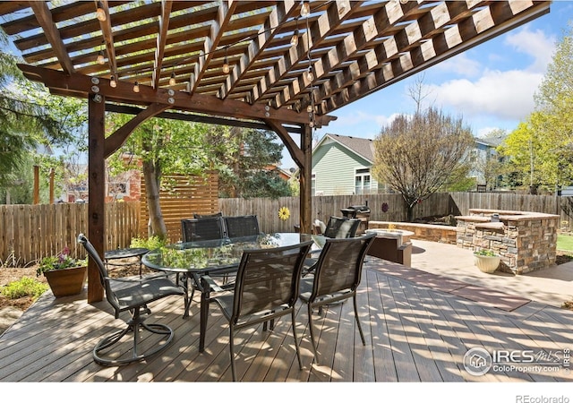 wooden deck with a fenced backyard, a pergola, and outdoor dining space