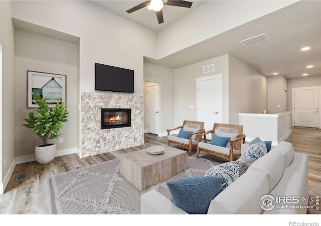 1755 Avery Plaza St, Severance, CO 80550 - living room featuring wood finished floors, ceiling fan, baseboards, a fireplace, and recessed lighting