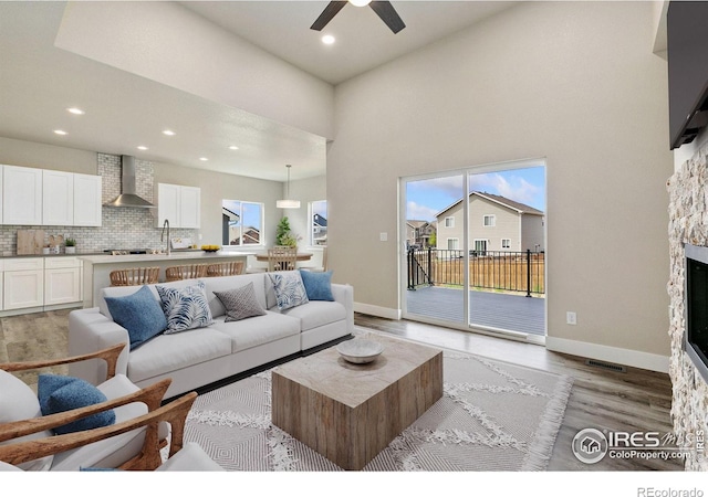 1755 Avery Plaza St, Severance, CO 80550 - living room with a ceiling fan, light wood-type flooring, recessed lighting, baseboards, and a fireplace
