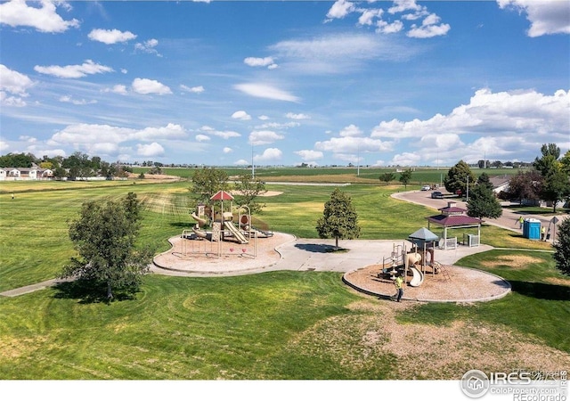 view of home's community with playground community and a yard