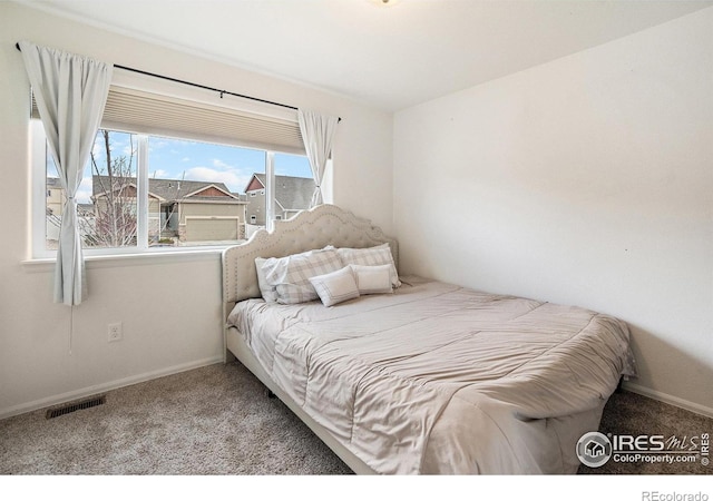 bedroom featuring carpet floors, visible vents, and baseboards