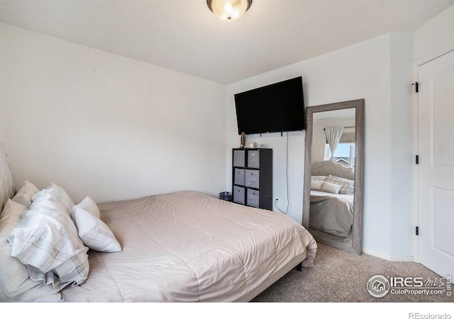bedroom featuring carpet flooring and baseboards