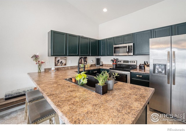 kitchen with stainless steel appliances, a peninsula, visible vents, a towering ceiling, and a breakfast bar area