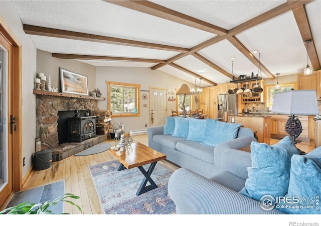 10649 Christopher Dr, Conifer, CO 80433 - living area with a baseboard radiator, a textured ceiling, light wood-style floors, an inviting chandelier, and baseboards