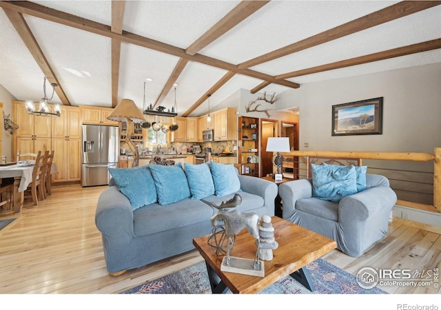 10649 Christopher Dr, Conifer, CO 80433 - living area with vaulted ceiling with beams, light wood-style flooring, and a notable chandelier