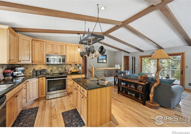 10649 Christopher Dr, Conifer, CO 80433 - kitchen featuring light wood finished floors, stainless steel appliances, lofted ceiling with beams, decorative backsplash, and open floor plan