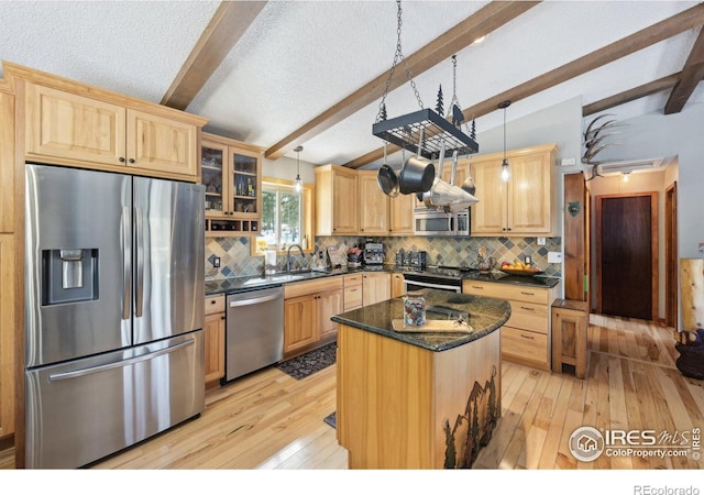 10649 Christopher Dr, Conifer, CO 80433 - kitchen with light brown cabinets, lofted ceiling with beams, stainless steel appliances, and light wood finished floors